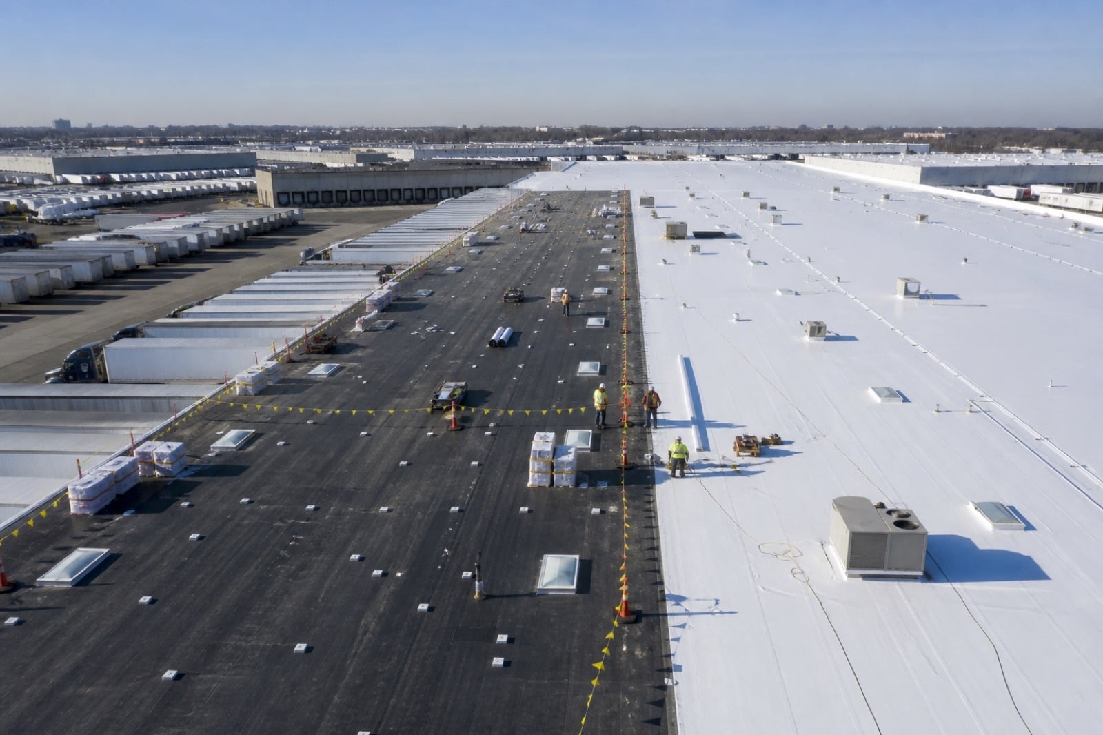 Large warehouse roof in an airport-adjacent commercial corridor